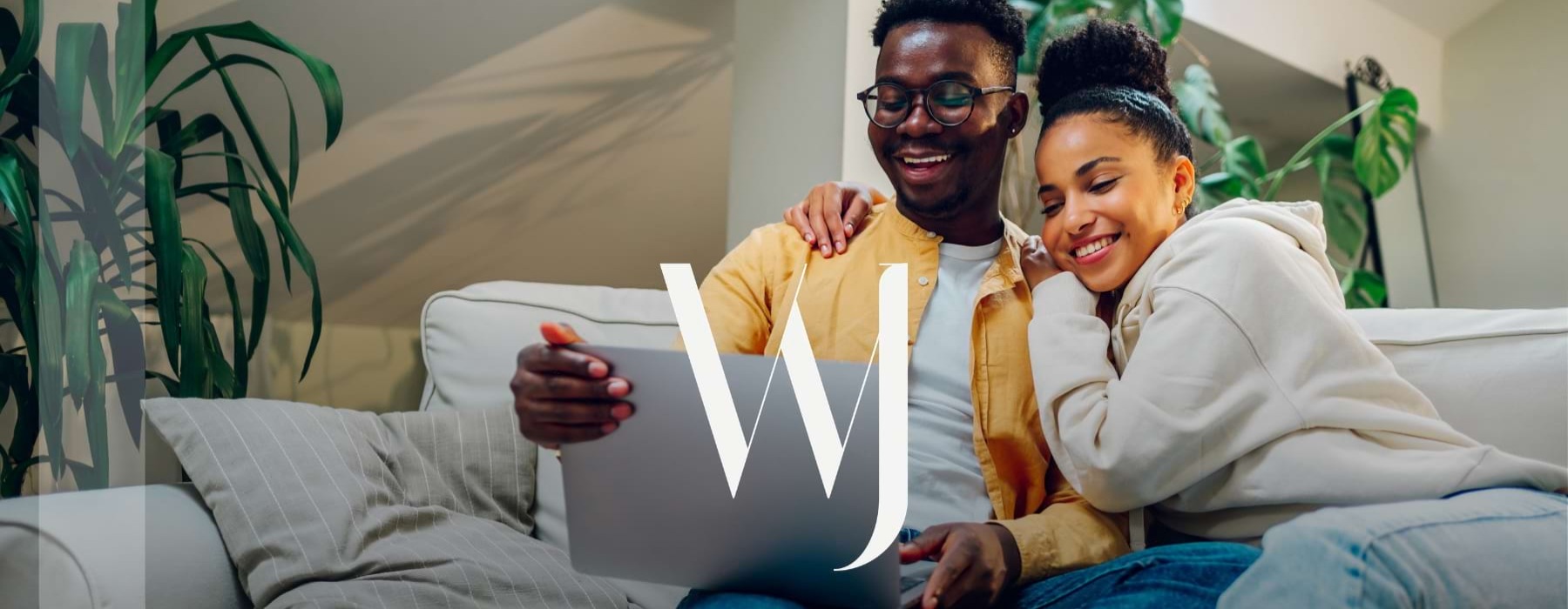 a couple on a couch with a laptop