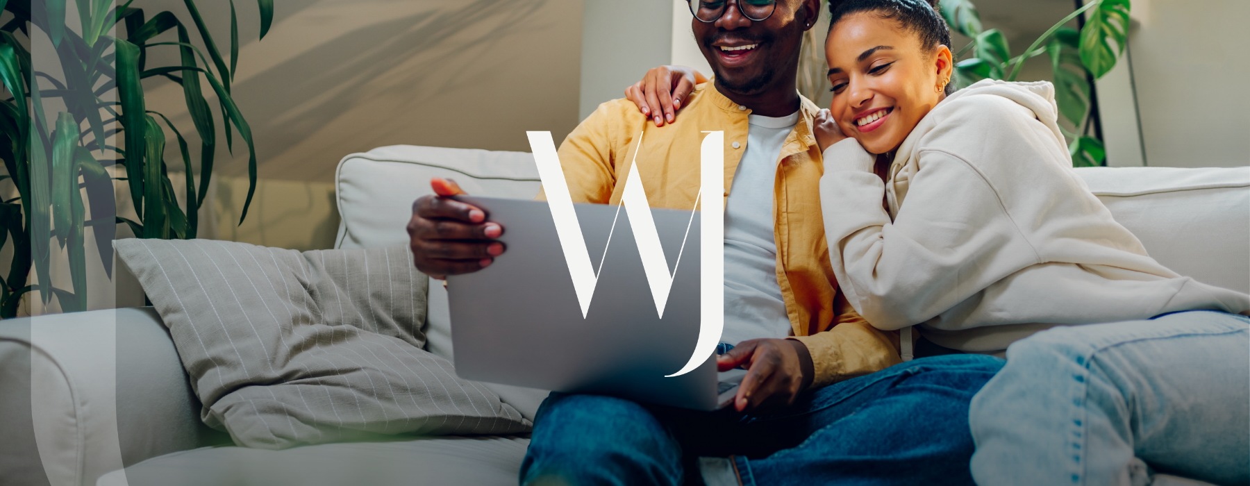 a couple on a couch with a laptop