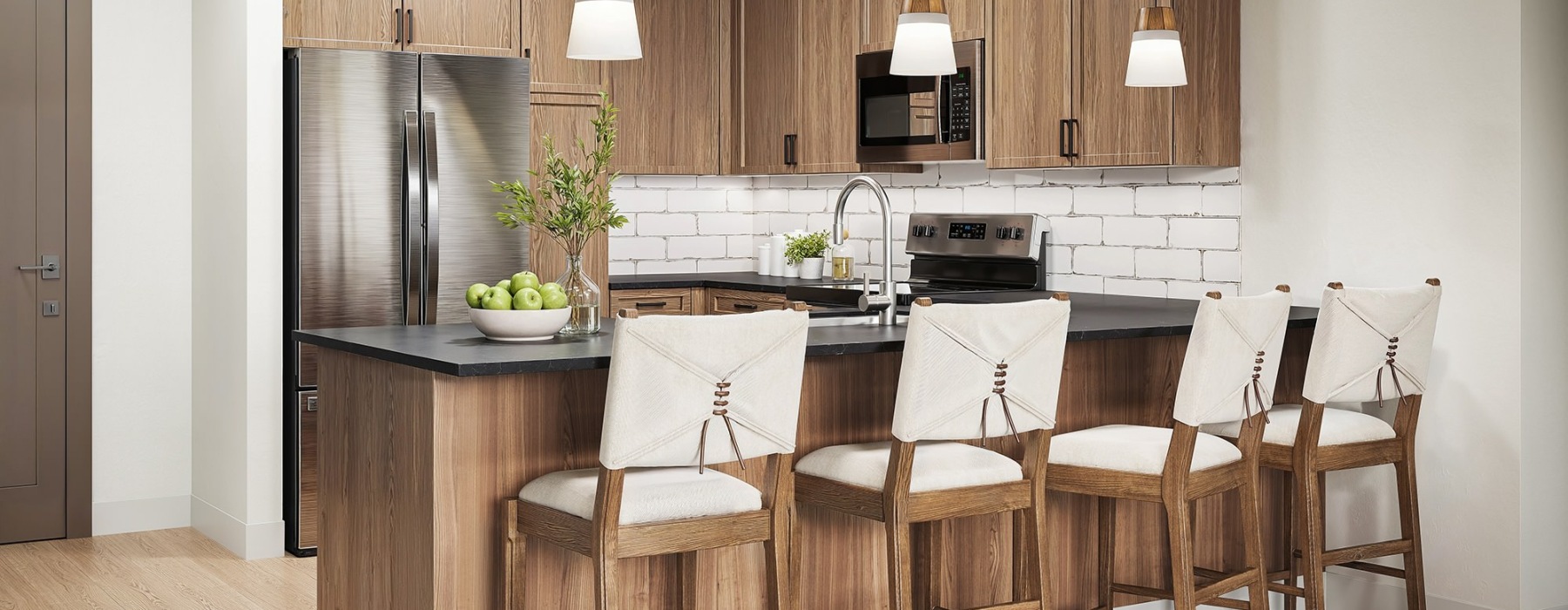 a kitchen with a bar and chairs